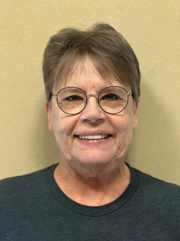 Patient of The Yuma Dentist showing off her new dental bridge